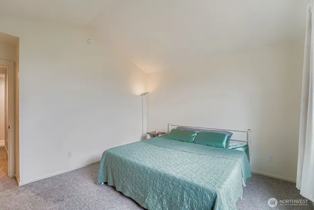 a bedroom with a bed and a night stand