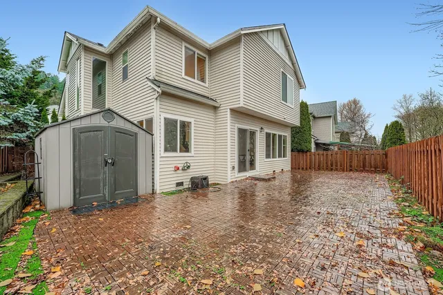 a view of a house with a yard and wooden fence
