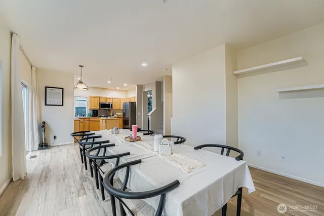 a view of a a dining room with furniture window and wooden floor