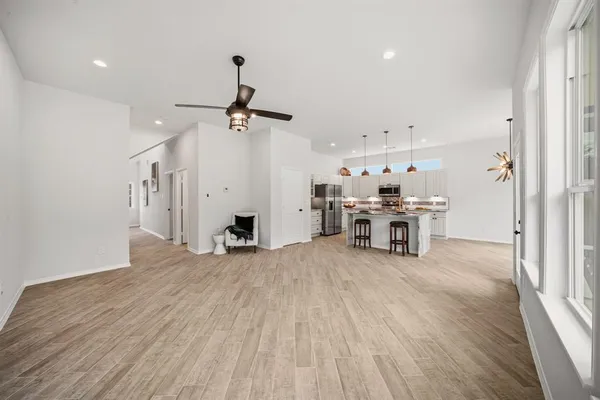 a view of a livingroom with furniture and a ceiling fan