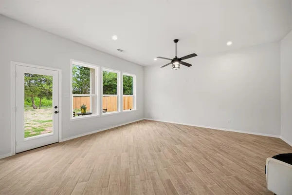 a view of a room with wooden floor and a window