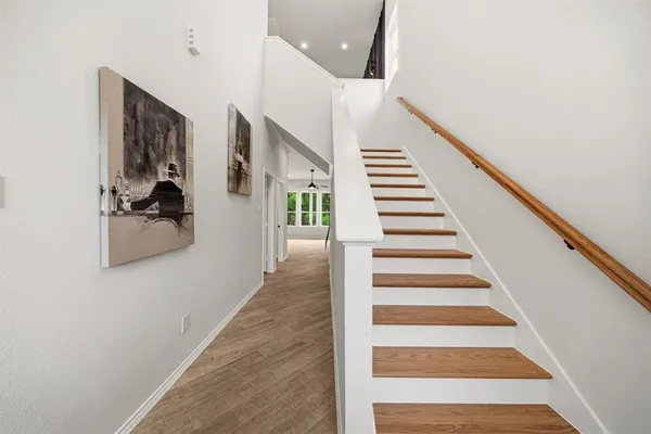 a view of entryway and hall with wooden floor