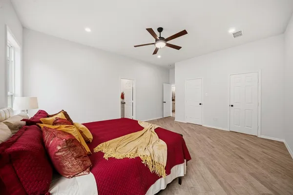 a bedroom with a bed and a chandelier