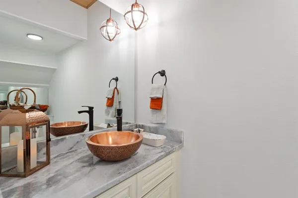 a view of a bathroom with a sink and mirror