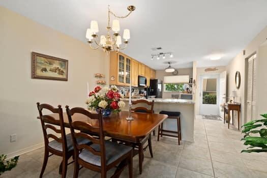 1351 Bayshore Drive, Unit 101 Fort Pierce, FL 34949 - Photo 12 of 37 a view of a dining room with furniture and a chandelier