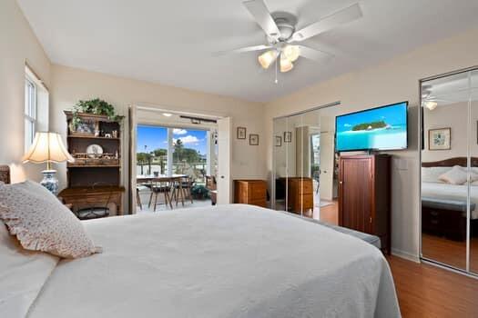 1351 Bayshore Drive, Unit 101 Fort Pierce, FL 34949 - Photo 21 of 37 a bedroom with a large bed and a chandelier