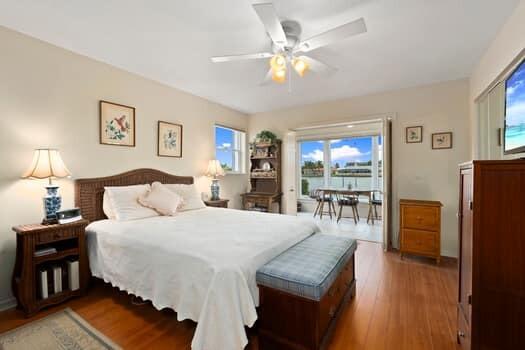 1351 Bayshore Drive, Unit 101 Fort Pierce, FL 34949 - Photo 22 of 37 a bedroom with a bed and a chandelier