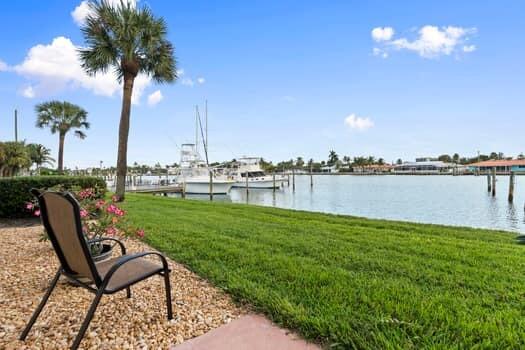 1351 Bayshore Drive, Unit 101 Fort Pierce, FL 34949 - Photo 30 of 37 a view of a lake with a table and chairs