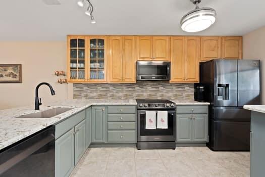 1351 Bayshore Drive, Unit 101 Fort Pierce, FL 34949 - Photo 8 of 37 a kitchen with stainless steel appliances granite countertop a stove a sink dishwasher a refrigerator and a microwave oven