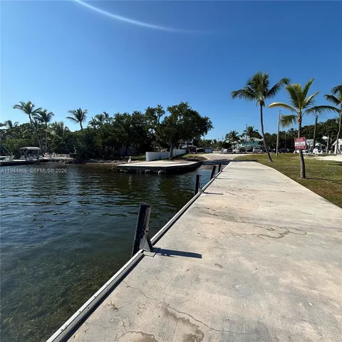 a view of swimming pool with outdoor seating and lake view