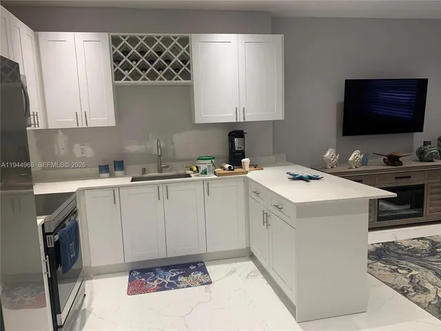 a kitchen with a sink stove and cabinets