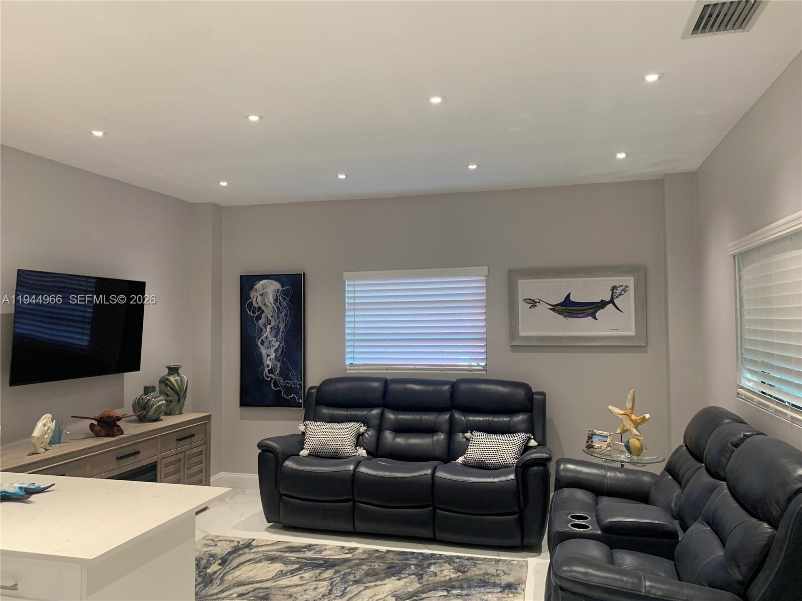 63 Bass Avenue, Unit 1 Key Largo, FL 33037 - Photo 3 of 9 a living room with furniture and a flat screen tv