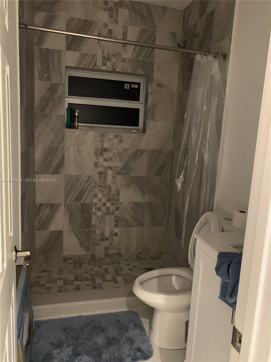 63 Bass Avenue, Unit 1 Key Largo, FL 33037 - Photo 5 of 9 a bathroom with a toilet and a shower