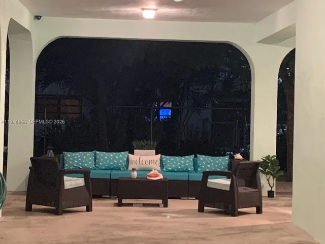 an outdoor living area with furniture