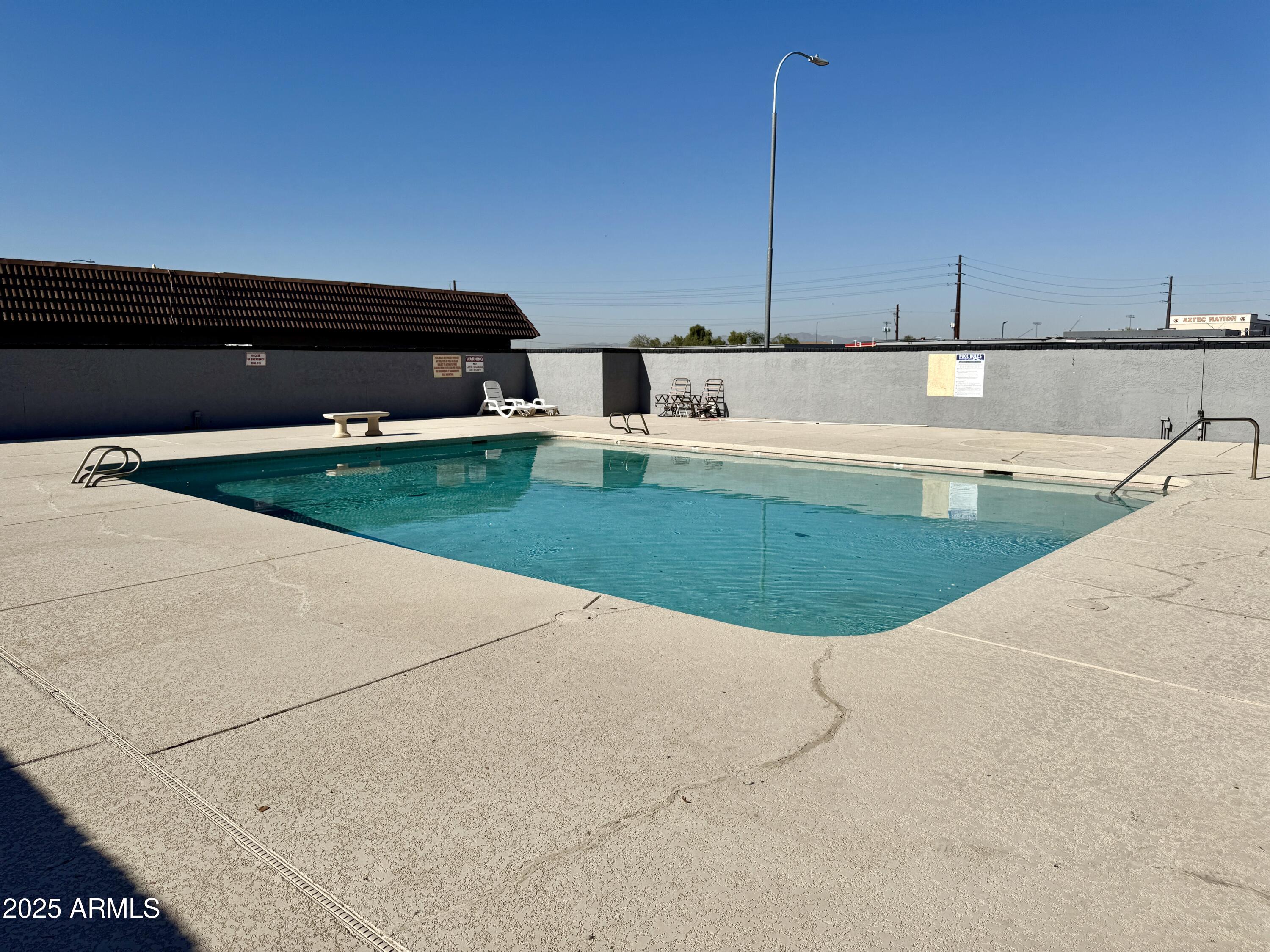 9015 West Elm Street, Unit 2 Phoenix, AZ 85037 - Photo 32 of 32 a view of a swimming pool with a yard