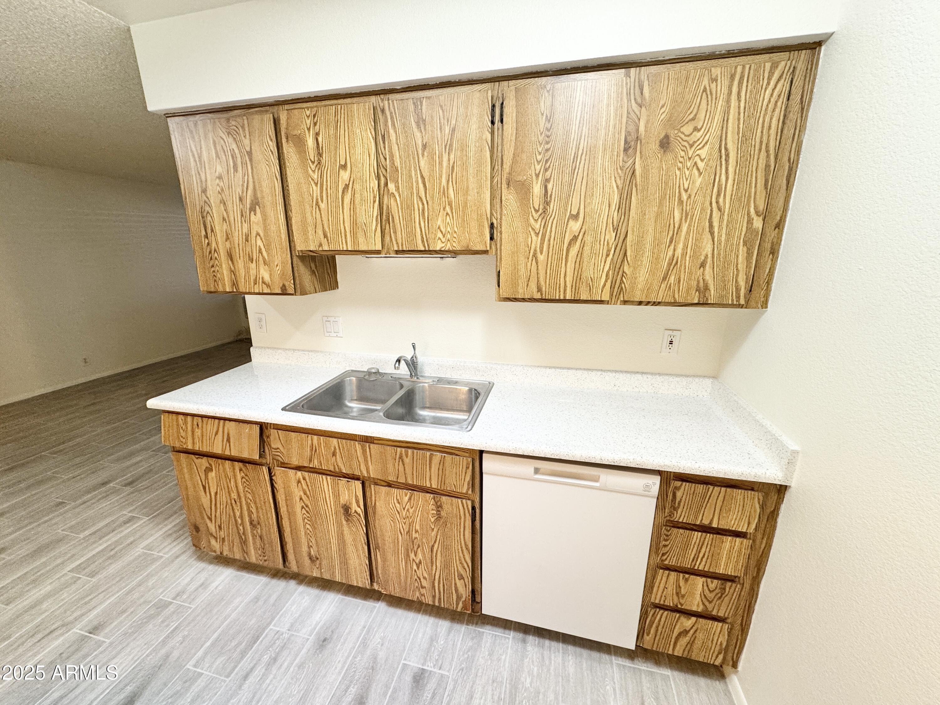 9015 West Elm Street, Unit 2 Phoenix, AZ 85037 - Photo 8 of 32 a close view of a sink and dishwasher with wooden floor