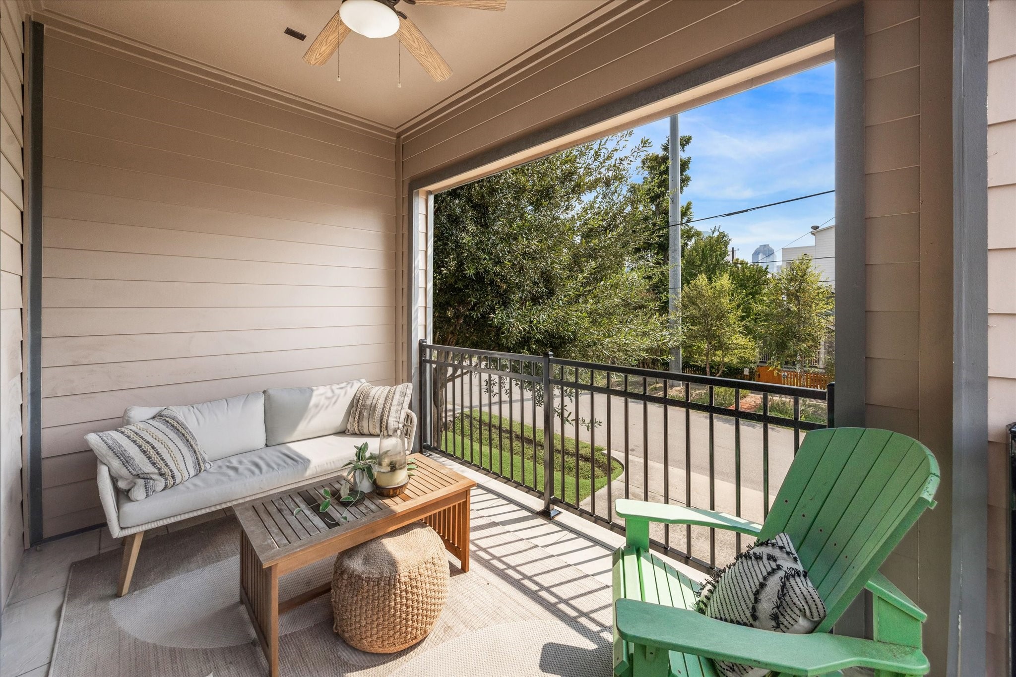 1702 Shearn Street Houston, TX 77007 - Photo 15 of 31 The living room opens to a balcony with a ceiling fan, creating a comfortable spot for outdoor lounging or entertaining.