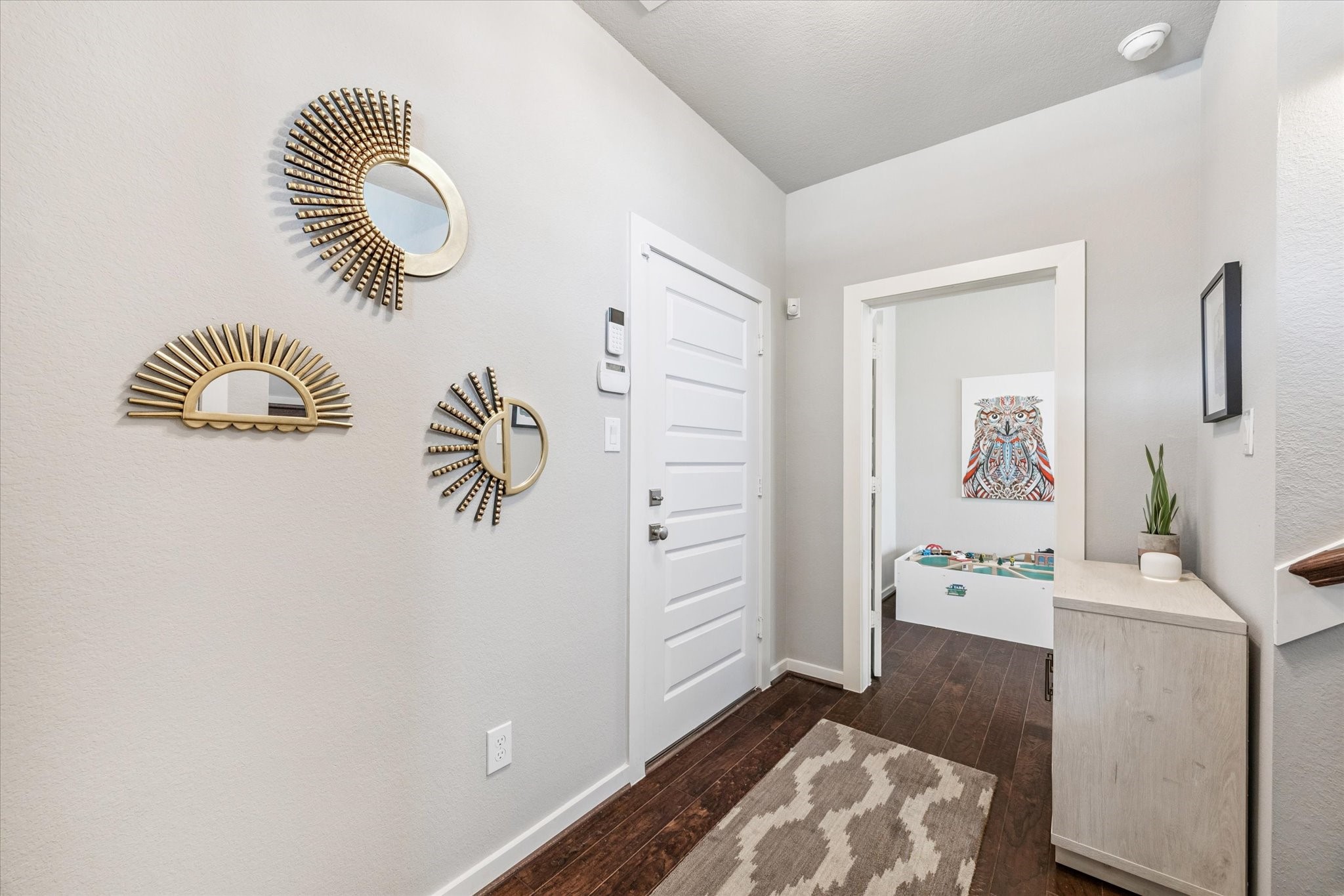 1702 Shearn Street Houston, TX 77007 - Photo 25 of 31 Upon entering the home you will notice the hardwood floors and tall ceilings. The door to the left leads to the attached 2 car garage.