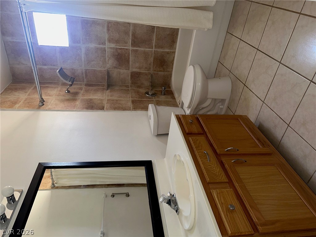 2050 West Warm Springs Road, Unit 1323 Henderson, NV 89014 - Photo 7 of 10 Functional bathroom featuring a shower, toilet, and vanity with ample storage.