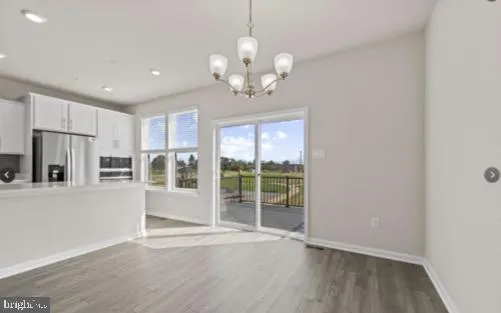 a view of an empty room with a kitchen