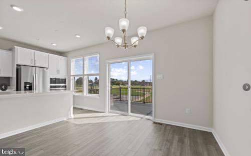 329 Ensemble Way Frederick, MD 21701 - Photo 11 of 20 a view of an empty room with a kitchen