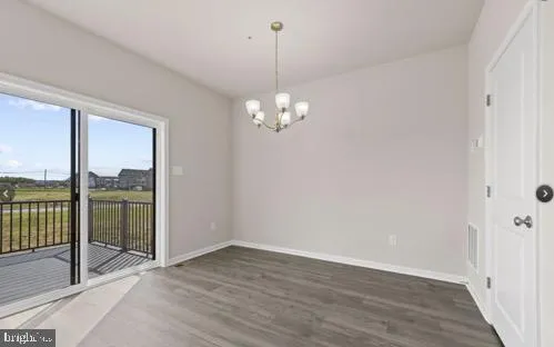 a view of a room with wooden floor and large windows