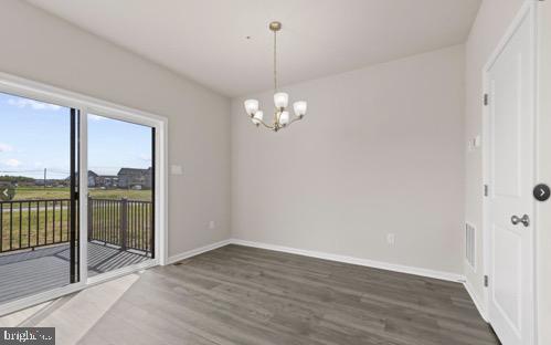 329 Ensemble Way Frederick, MD 21701 - Photo 13 of 20 a view of a room with wooden floor and large windows