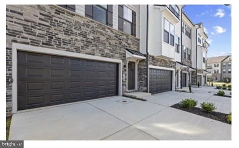 329 Ensemble Way Frederick, MD 21701 - Photo 2 of 20 a view of a pathway along the building