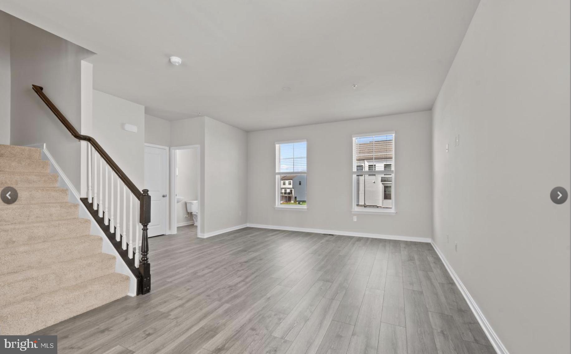 329 Ensemble Way Frederick, MD 21701 - Photo 4 of 20 a view of an empty room with wooden floor and a window