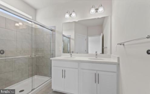 329 Ensemble Way Frederick, MD 21701 - Photo 7 of 20 a bathroom with a double vanity sink mirror and shower