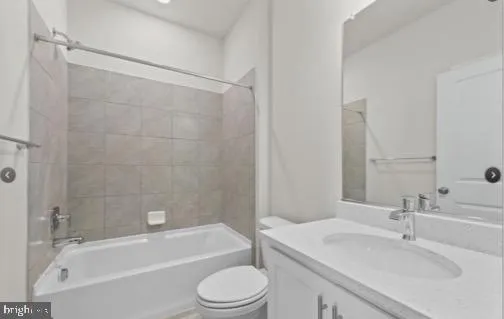 a bathroom with a bathtub shower sink vanity mirror and toilet