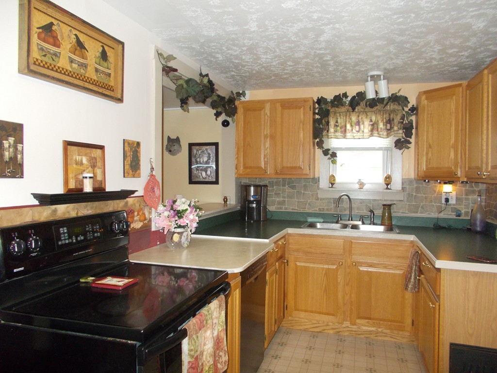 1653 Petersham Road Athol, MA 01331 - Photo 2 of 9 a kitchen with stainless steel appliances granite countertop a sink stove and cabinets