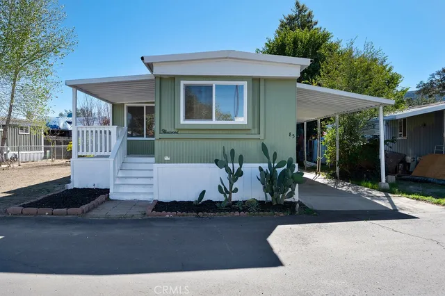 a view of a house with backyard and sitting area