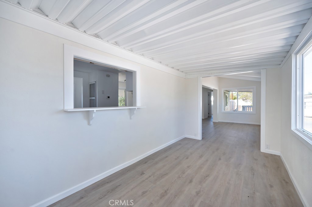 26455 Paradise Valley Road, Unit 85 Warner Springs, CA 92086 - Photo 13 of 36 an empty room with wooden floor and windows