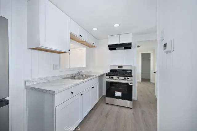 a kitchen with stainless steel appliances granite countertop a stove and a sink