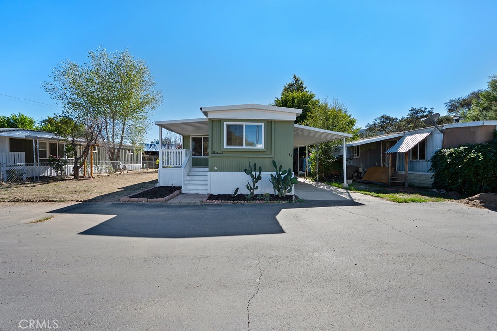 26455 Paradise Valley Road, Unit 85 Warner Springs, CA 92086 - Photo 2 of 36 a front view of a house with a yard and potted plants