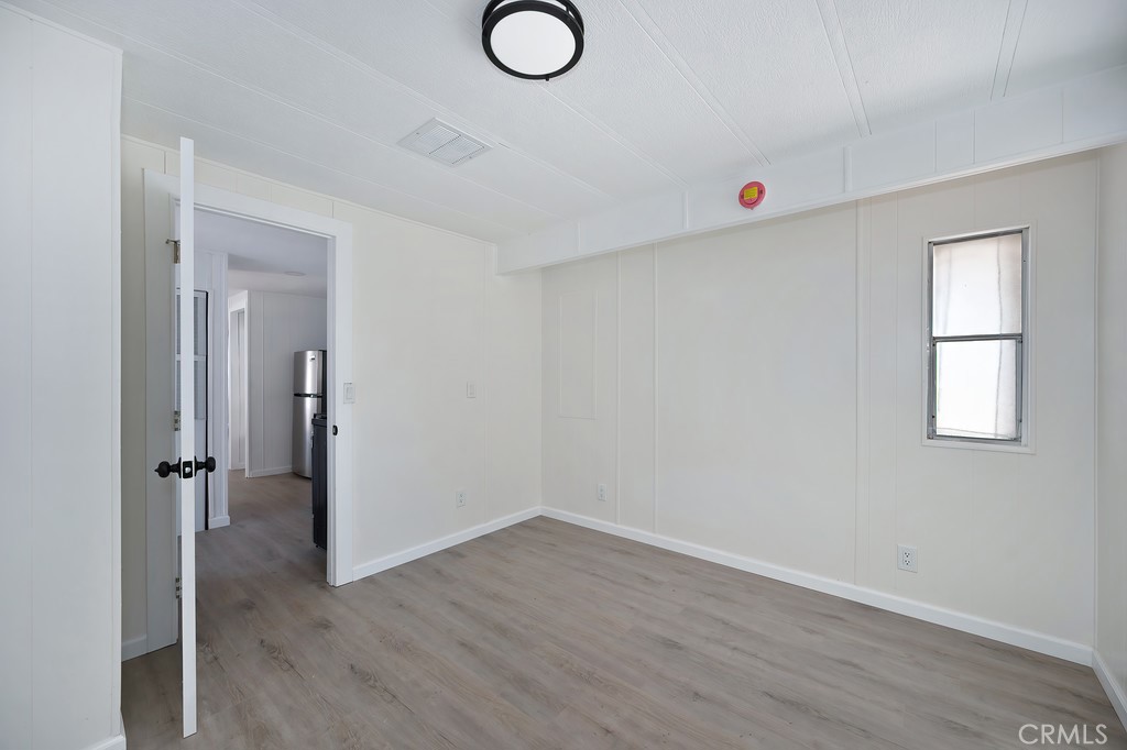 26455 Paradise Valley Road, Unit 85 Warner Springs, CA 92086 - Photo 25 of 36 an empty room with wooden floor and window