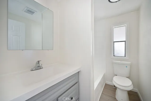 a bathroom with a sink toilet and vanity