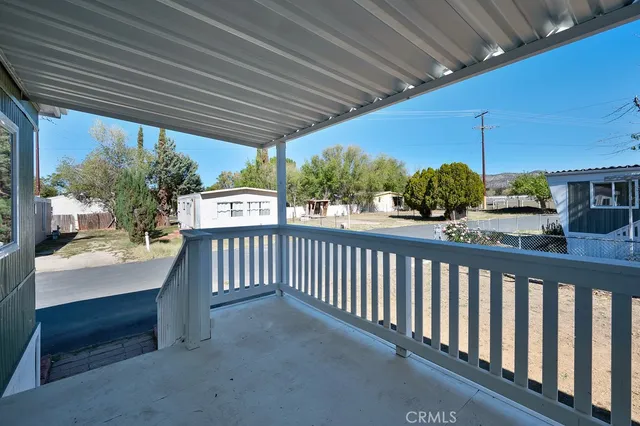 a view of a porch with wooden floor