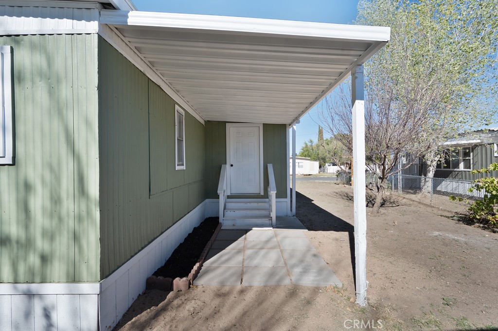 26455 Paradise Valley Road, Unit 85 Warner Springs, CA 92086 - Photo 32 of 36 a bedroom with a bed and a chandelier