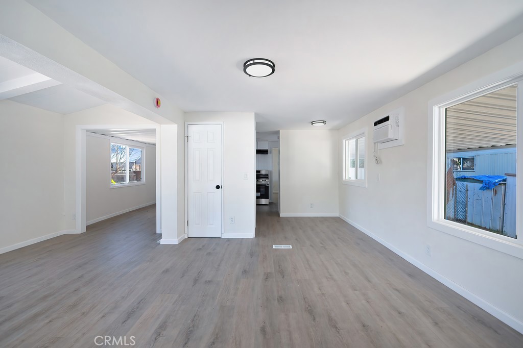 26455 Paradise Valley Road, Unit 85 Warner Springs, CA 92086 - Photo 8 of 36 an empty room with wooden floor and windows