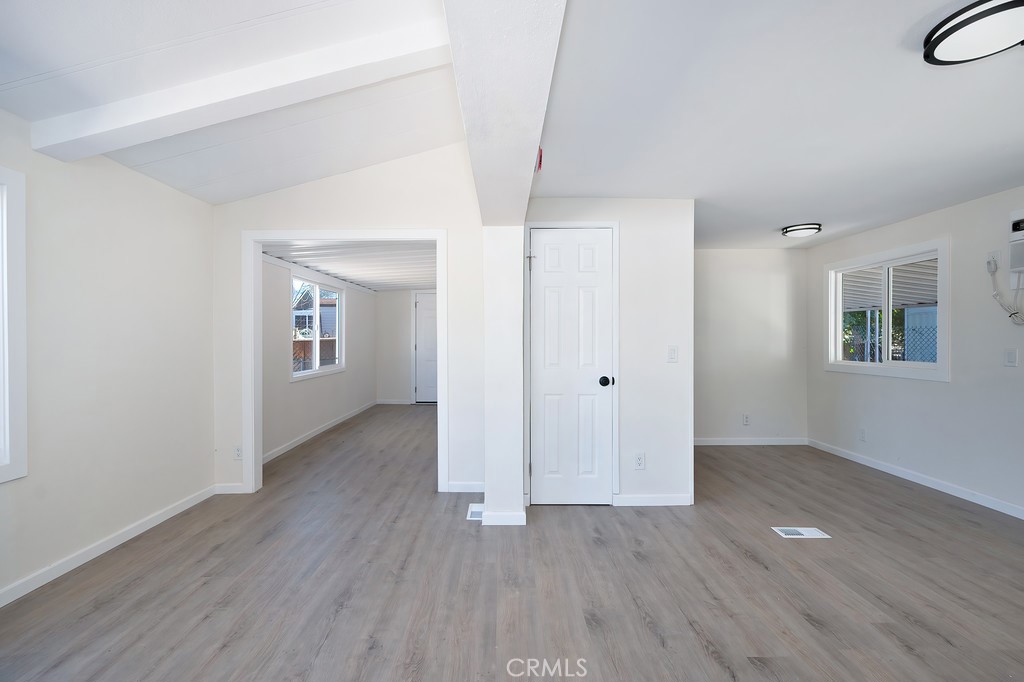 26455 Paradise Valley Road, Unit 85 Warner Springs, CA 92086 - Photo 9 of 36 an empty room with wooden floor and windows