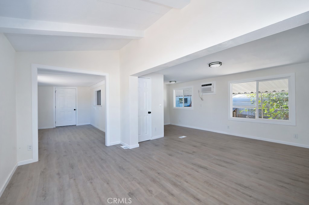 26455 Paradise Valley Road, Unit 85 Warner Springs, CA 92086 - Photo 10 of 36 an empty room with wooden floor and windows