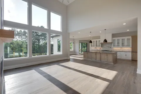 a large white kitchen with a large window
