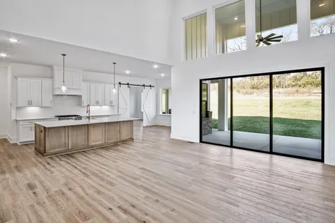 a view of kitchen with kitchen island wooden floor and window