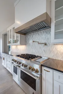 a white stove top oven sitting inside of a kitchen