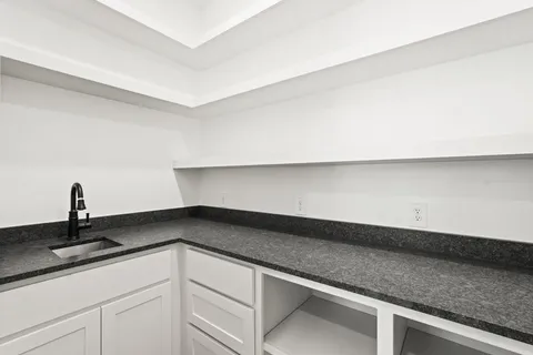 a kitchen with a sink and cabinets