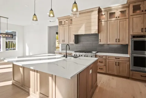 a kitchen with a sink stove and cabinets