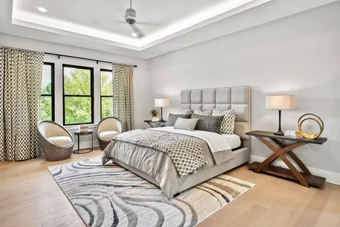 a bedroom with a bed and a large window