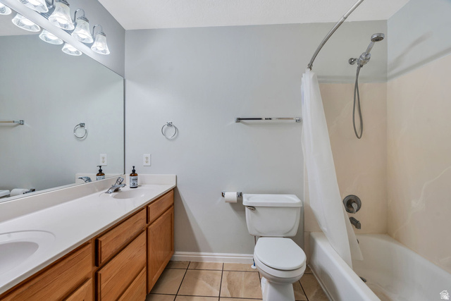 986 Independence Avenue Provo, UT 84604 - Photo 14 of 29 Bathroom featuring a single vanity with wood-finish cabinetry, a large wall-mounted mirror, overhead vanity lighting, a toilet, and a combined shower and bathtub